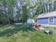 Lush backyard featuring a cozy fire pit area, a hammock, a shed and ample space for activities at 173 Springwater Trce, Woodstock, GA 30188