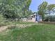 Expansive backyard features a wooden fence, a lush green lawn, and mature trees at 173 Springwater Trce, Woodstock, GA 30188