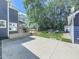 Backyard of house with covered deck, fire pit, lush green lawn, and mature trees at 173 Springwater Trce, Woodstock, GA 30188