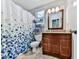 This bathroom features tile floors, granite counters, and a shower with a curtain at 173 Springwater Trce, Woodstock, GA 30188