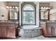 This bathroom offers a tub, dual sink vanities, and a big window at 173 Springwater Trce, Woodstock, GA 30188