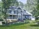 Charming two-story home with a covered porch, mature trees, and an attached garage at 173 Springwater Trce, Woodstock, GA 30188