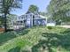 Beautifully landscaped front yard showcasing a spacious two-story home with a garage at 173 Springwater Trce, Woodstock, GA 30188