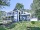 Charming two-story home with a covered porch, crisp white trim, and a separate garage at 173 Springwater Trce, Woodstock, GA 30188