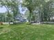 Well-manicured front lawn showcasing a beautiful two-story home with mature trees and landscaping at 173 Springwater Trce, Woodstock, GA 30188