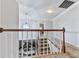 Hallway with railing overlooking living room and staircase with carpet at 173 Springwater Trce, Woodstock, GA 30188