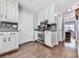 Galley style kitchen with white cabinets, granite countertops, and stainless appliances at 173 Springwater Trce, Woodstock, GA 30188
