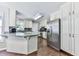 Kitchen with white cabinets, granite countertops, stainless appliances, and hardwood floors at 173 Springwater Trce, Woodstock, GA 30188