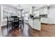 Bright eat-in kitchen with white cabinets, mosaic backsplash and hardwood floors at 173 Springwater Trce, Woodstock, GA 30188