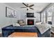 Comfortable living room features a fireplace, ceiling fan, and oversized blue couch at 173 Springwater Trce, Woodstock, GA 30188
