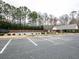 Exterior view of the community swimming pool and clubhouse with ample parking at 173 Springwater Trce, Woodstock, GA 30188