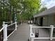 Expansive deck surrounded by mature trees, offering ample space for outdoor living and entertaining at 235 Creekside Way, Mcdonough, GA 30252