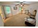 Spacious bedroom boasting two large windows, neutral walls and a ceiling fan at 235 Creekside Way, Mcdonough, GA 30252