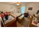 Cozy bedroom featuring neutral tones, a ceiling fan and a large window for ample natural light at 235 Creekside Way, Mcdonough, GA 30252