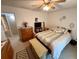 A comfortable bedroom featuring neutral walls, a ceiling fan, and access to the en-suite bathroom at 235 Creekside Way, Mcdonough, GA 30252