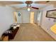 Large bedroom showcasing multiple doorways, neutral walls, ceiling fan and a window at 235 Creekside Way, Mcdonough, GA 30252