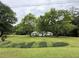 Quaint single-story home with a large front yard and mature trees, offering a serene setting at 235 Creekside Way, Mcdonough, GA 30252