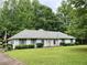 Charming single-story home with a well-maintained lawn and mature trees providing ample shade at 235 Creekside Way, Mcdonough, GA 30252