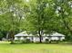 Traditional single-story house with a symmetrical facade, lush green lawn, and large trees at 235 Creekside Way, Mcdonough, GA 30252