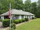 Charming single-story home with an American flag and manicured landscaping at 235 Creekside Way, Mcdonough, GA 30252