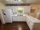 Well-lit kitchen offering ample counter space and modern white appliances at 235 Creekside Way, Mcdonough, GA 30252