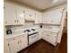 Charming kitchen with white cabinets, stainless steel appliances, and hardwood flooring at 235 Creekside Way, Mcdonough, GA 30252