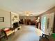 Open-concept living room with a brick fireplace, neutral tones, and access to the front entry at 235 Creekside Way, Mcdonough, GA 30252