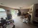 Spacious living room with a brick fireplace, ceiling fan, and entry to the outdoors at 235 Creekside Way, Mcdonough, GA 30252
