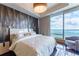 Comfortable bedroom with king bed, designer wallpaper, and large windows boasting city views at 3344 Peachtree Rd # 3505, Atlanta, GA 30326