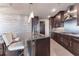 Stylish kitchen featuring dark wood cabinetry, granite countertops, and a breakfast bar at 3344 Peachtree Rd # 3505, Atlanta, GA 30326