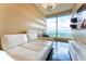 Bright living room with white couch and floor-to-ceiling windows with expansive views at 3344 Peachtree Rd # 3505, Atlanta, GA 30326