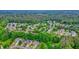 An aerial view shows a neighborhood with mature trees and winding streets at 4170 Haynes Mill Nw Ct, Kennesaw, GA 30144