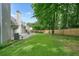 Large backyard with grass and a patio featuring an outdoor seating area and a grill at 4170 Haynes Mill Nw Ct, Kennesaw, GA 30144