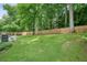 Backyard patio with a table, chairs, grill, and a lawn with a wood fence at 4170 Haynes Mill Nw Ct, Kennesaw, GA 30144