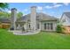 Backyard patio with a table, chairs, grill, a landscaped yard, and a lawn at 4170 Haynes Mill Nw Ct, Kennesaw, GA 30144