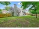 Backyard with well-maintained lawn, a patio area with seating, and a wooden fence at 4170 Haynes Mill Nw Ct, Kennesaw, GA 30144