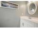 Clean bathroom featuring a white vanity and a framed mirror at 4170 Haynes Mill Nw Ct, Kennesaw, GA 30144