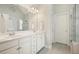 Bright bathroom features double vanity, large mirror, and shower with glass door at 4170 Haynes Mill Nw Ct, Kennesaw, GA 30144