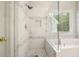 Bathroom featuring glass shower with mosaic tile and luxurious soaking tub at 4170 Haynes Mill Nw Ct, Kennesaw, GA 30144