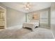 Bedroom features neutral walls, carpet, and two windows at 4170 Haynes Mill Nw Ct, Kennesaw, GA 30144