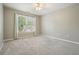 This bright bedroom features a large window with a ceiling fan and plush carpet at 4170 Haynes Mill Nw Ct, Kennesaw, GA 30144