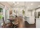 Dining area with a view into the living room and kitchen featuring a round table and natural light at 4170 Haynes Mill Nw Ct, Kennesaw, GA 30144