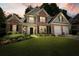 Charming two-story home with brick accents, manicured lawn, and lush landscaping at 4170 Haynes Mill Nw Ct, Kennesaw, GA 30144