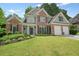 Charming two-story home with brick accents, manicured lawn, and lush landscaping at 4170 Haynes Mill Nw Ct, Kennesaw, GA 30144