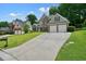 Well-maintained two-story home with a long driveway and mature trees in a residential neighborhood at 4170 Haynes Mill Nw Ct, Kennesaw, GA 30144
