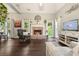Bright living room featuring a brick fireplace and beautiful dark hardwood floors at 4170 Haynes Mill Nw Ct, Kennesaw, GA 30144