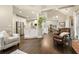 Open-concept living room featuring a brick fireplace, dark wood floors, and lots of natural light at 4170 Haynes Mill Nw Ct, Kennesaw, GA 30144