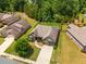 Stunning aerial view of a home with a well-maintained lawn, mature trees, and nice neighborhood at 6995 Tybridge St, Cumming, GA 30040