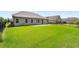 Expansive green backyard with a black iron fence and a view of neighboring houses at 6995 Tybridge St, Cumming, GA 30040