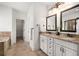 Bathroom featuring double vanity, granite countertops, and tiled floors at 6995 Tybridge St, Cumming, GA 30040